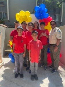 Boy Scouts of America posing with balloons in the background.
