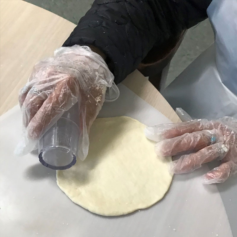 Woman baking a tortilla.